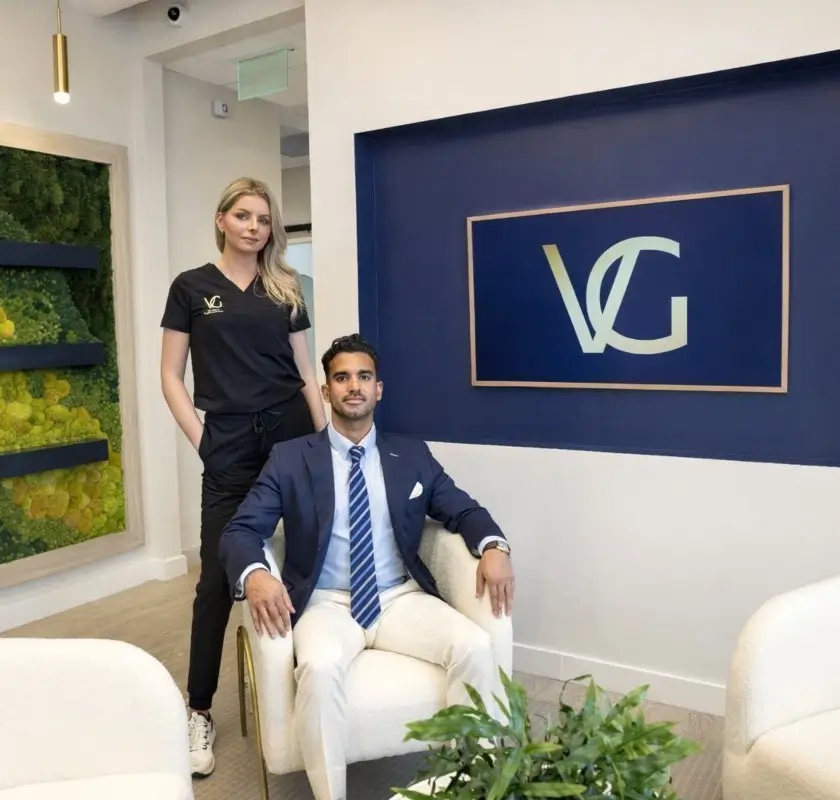 Dr. Vipul Gargya, board-certified plastic surgeon, seated in the VG Signature luxury plastic surgery office in Tampa, Florida
